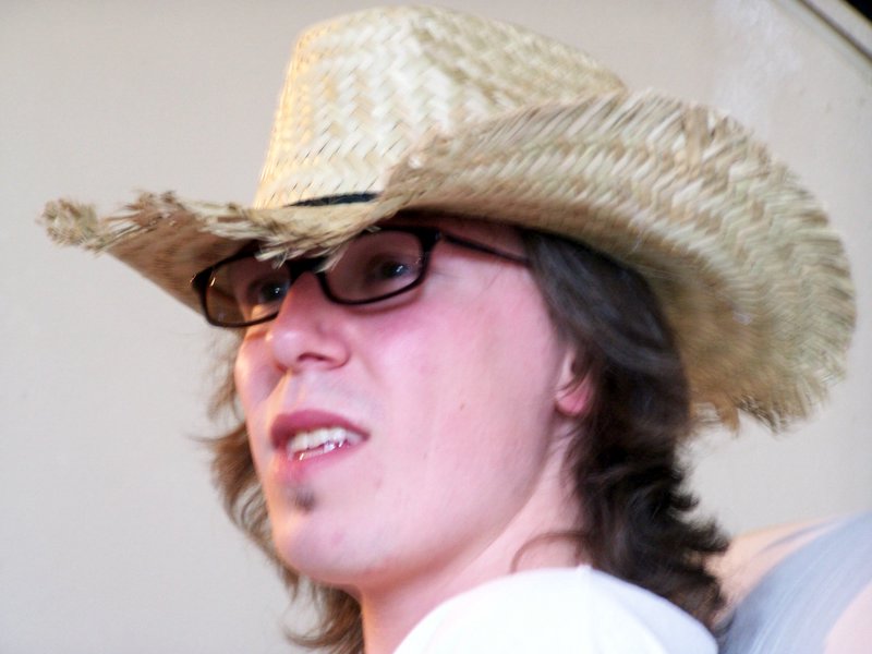 a woman wearing a straw hat and glasses