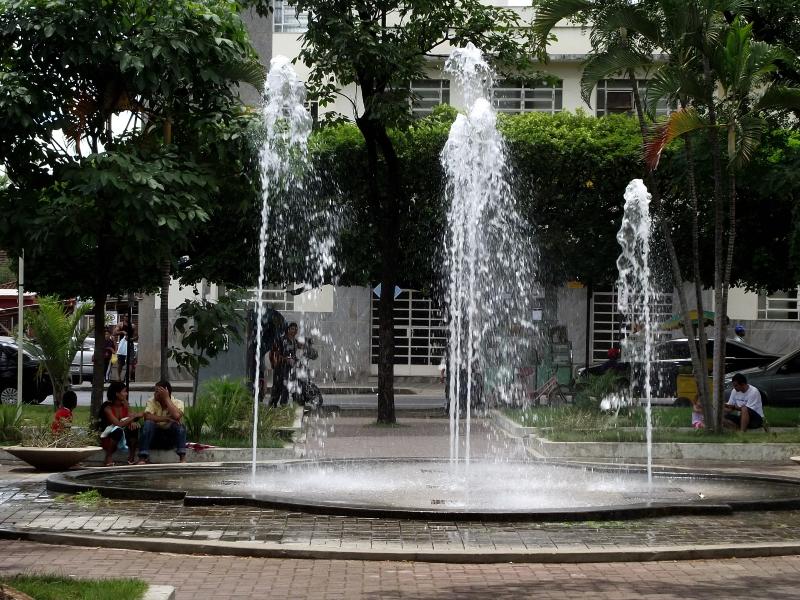 a large white fountain in the middle of the city