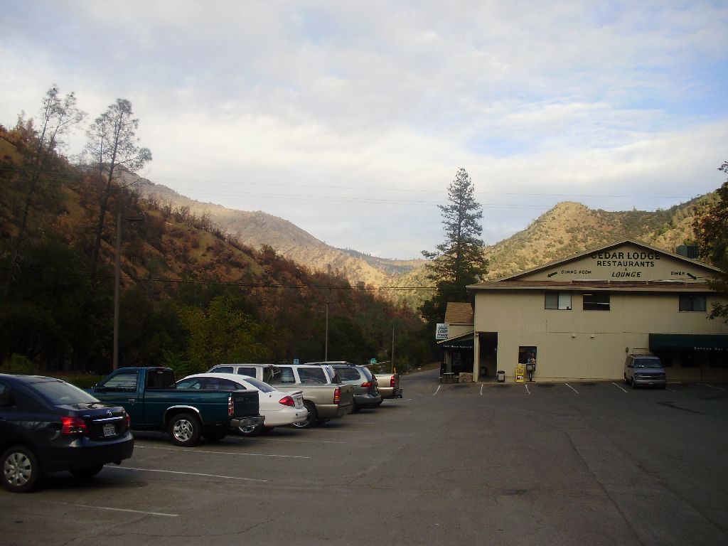 parking lot with mountains and woods in background