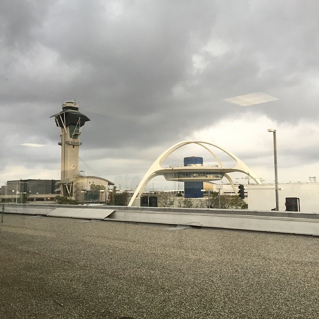 an air traffic signal is in front of a modern structure