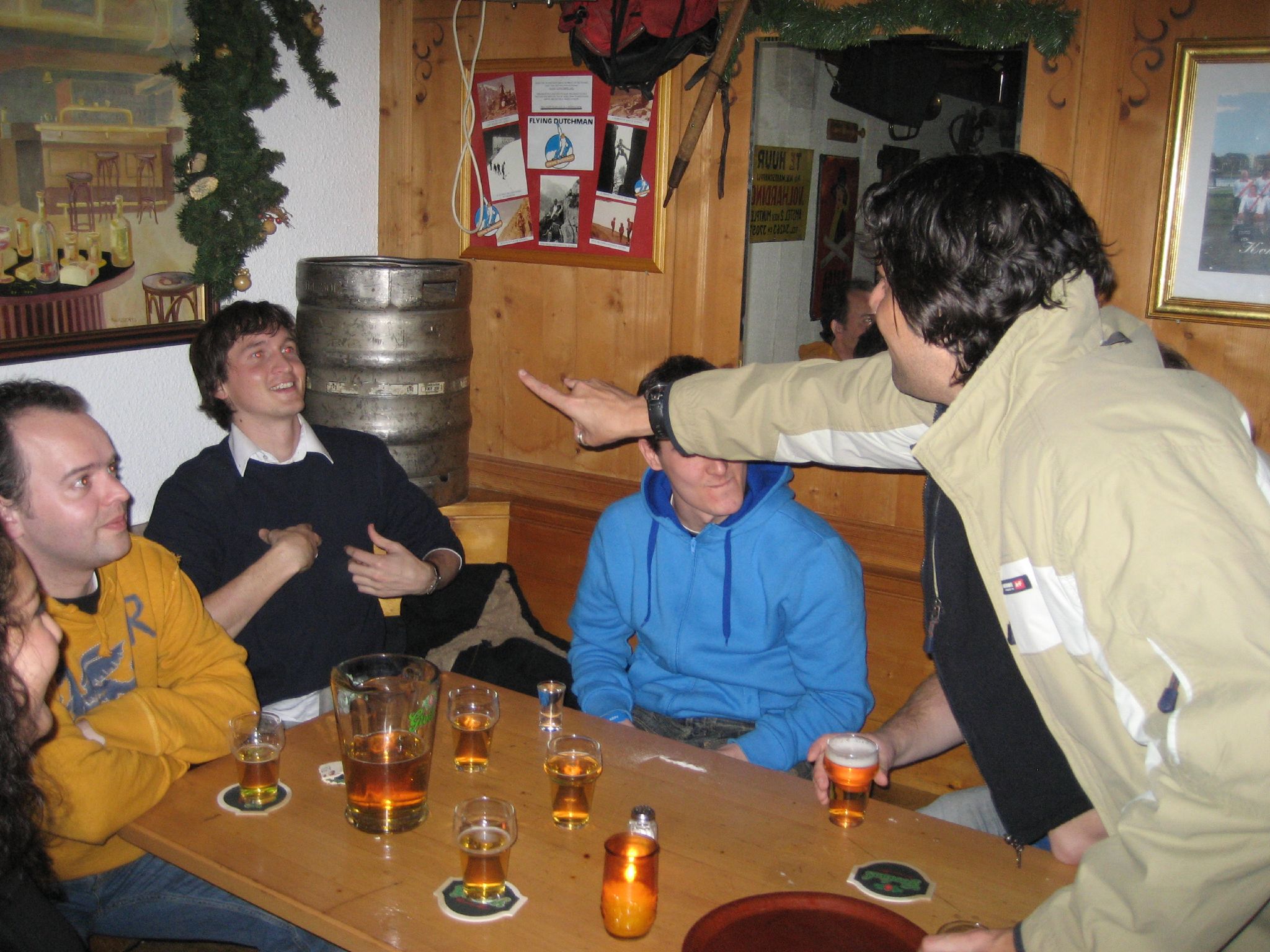 a group of people sit around a bar, talking