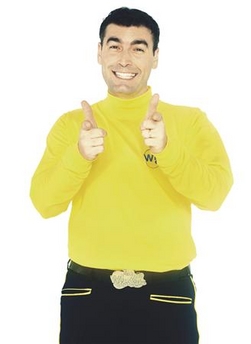 a man wearing a yellow sweater showing thumbs up