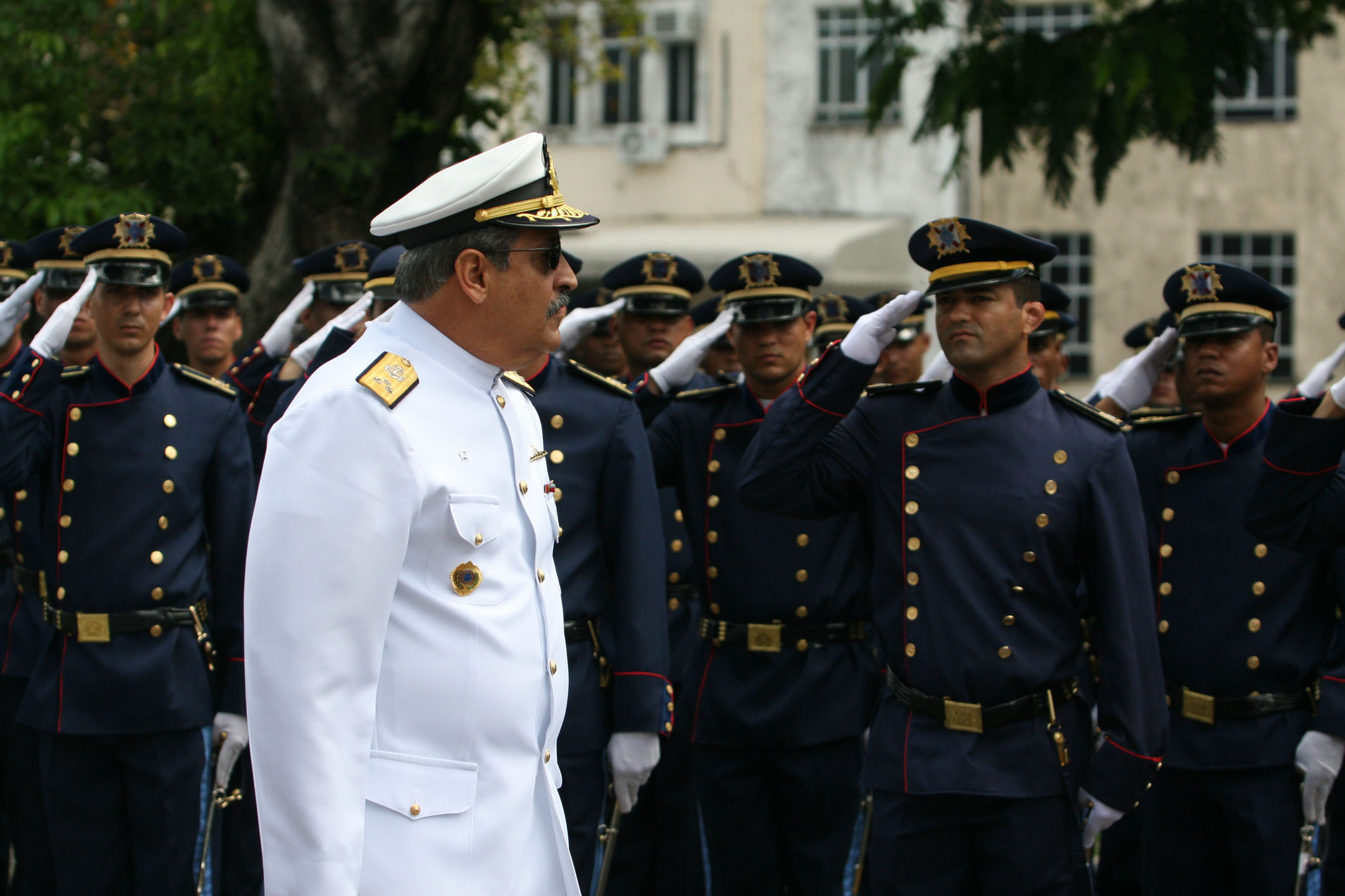 a military man looking at other people while he looks off to the side