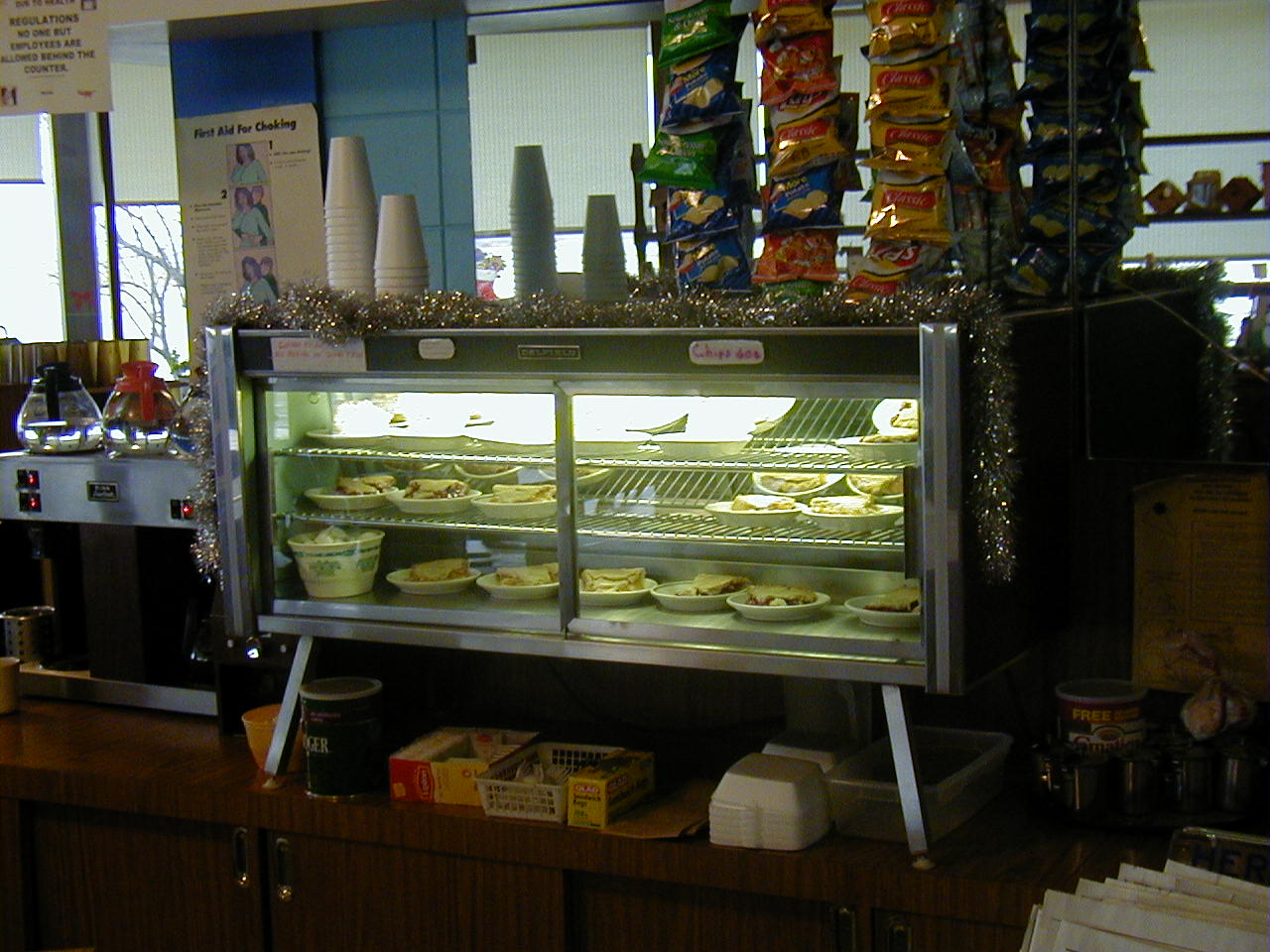 a pastry display case in a store filled with items