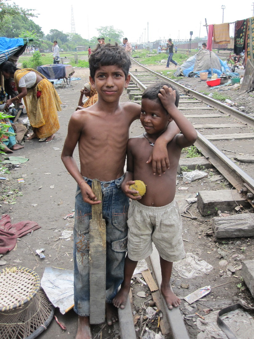 two s standing next to each other near railroad tracks