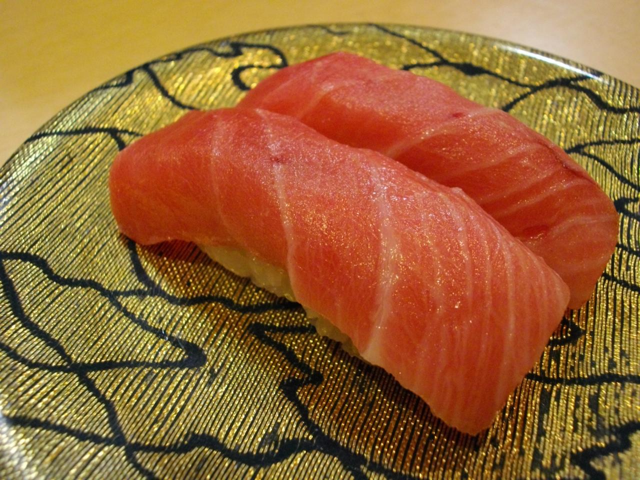 a close up of two slices of sushi on a plate
