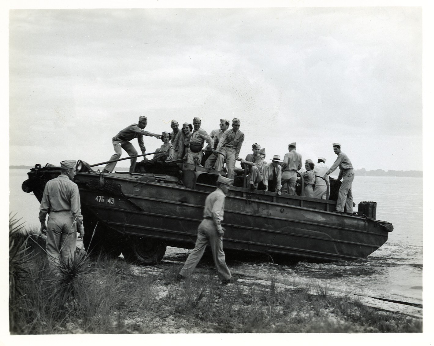 a black and white picture of people on a small boat