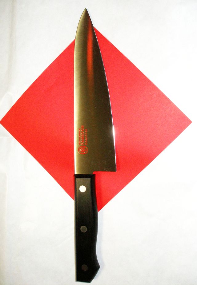 a large kitchen knife on top of a white cloth