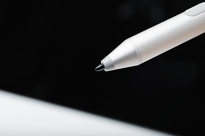 a close up of a white pen with a black background