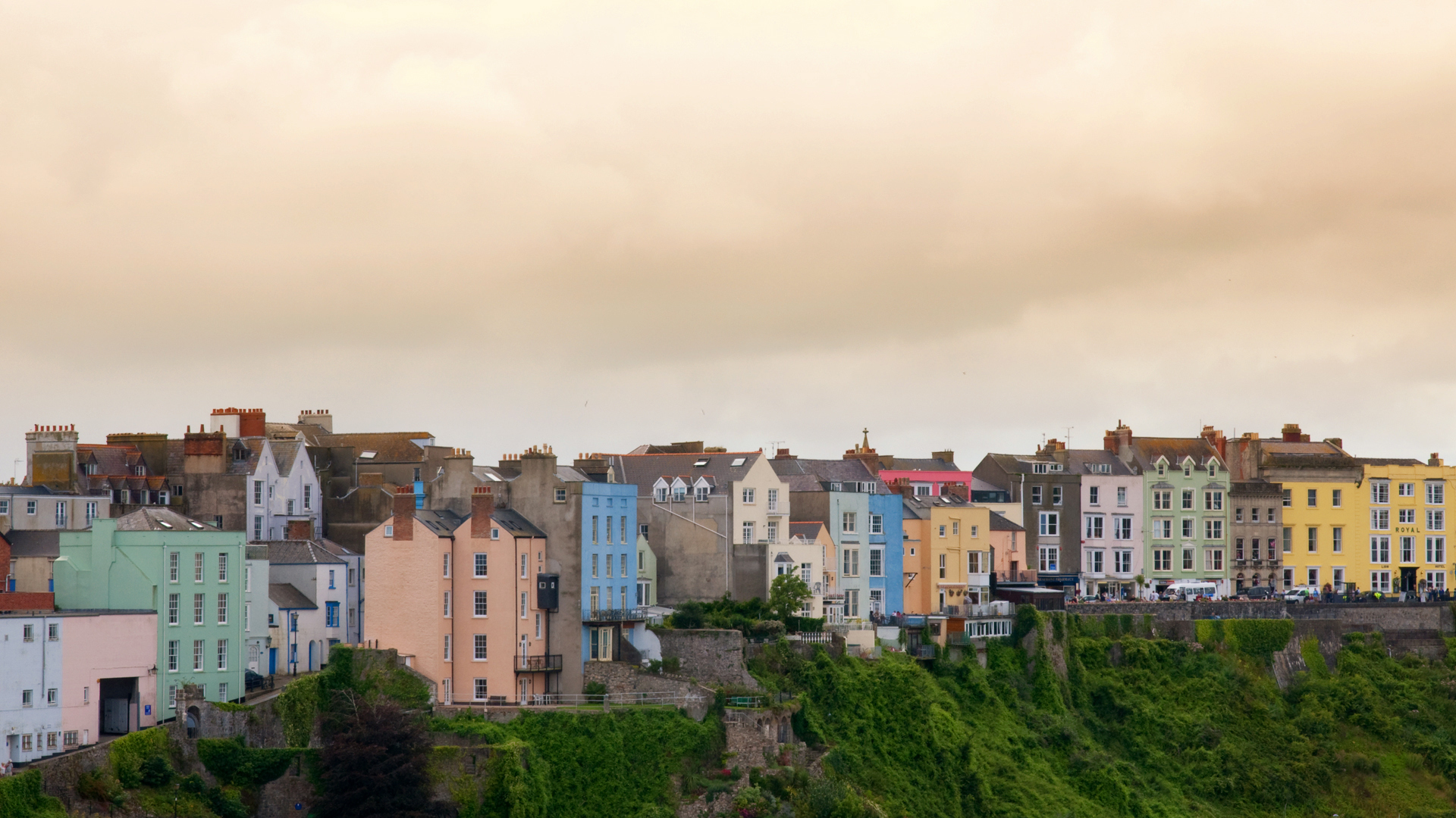 a group of colorful buildings in an area on a hillside