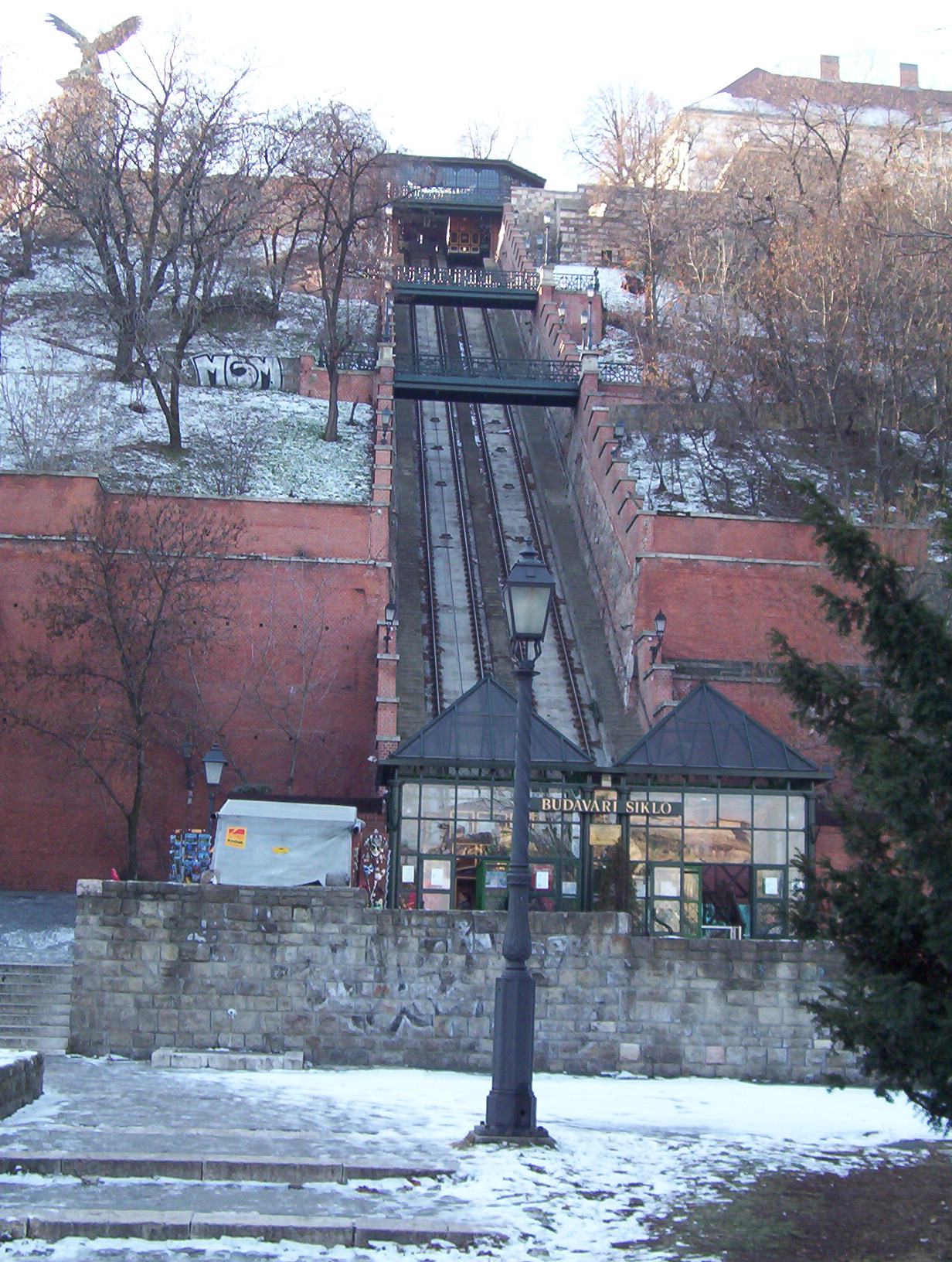 an escalator and clock tower in the middle of the winter