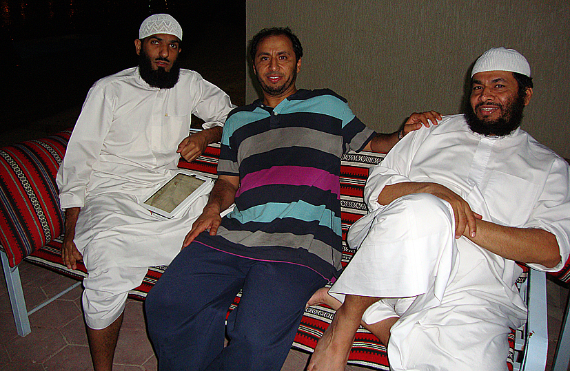 a group of men laying down on top of a blanket