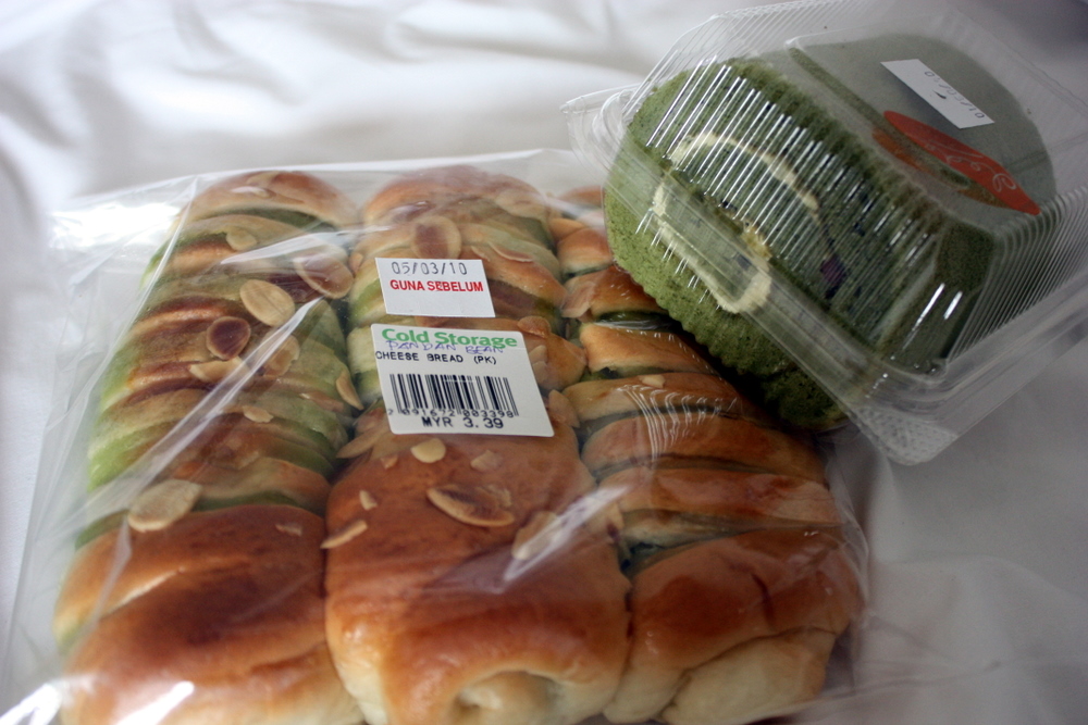 several rolls in plastic wrap with various toppings