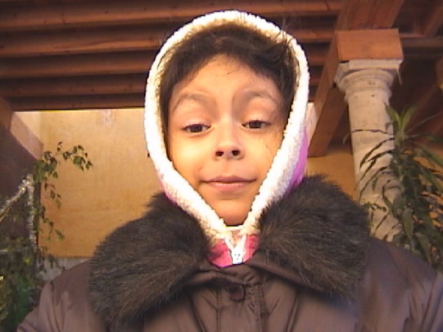 a girl wearing a hood and jacket on