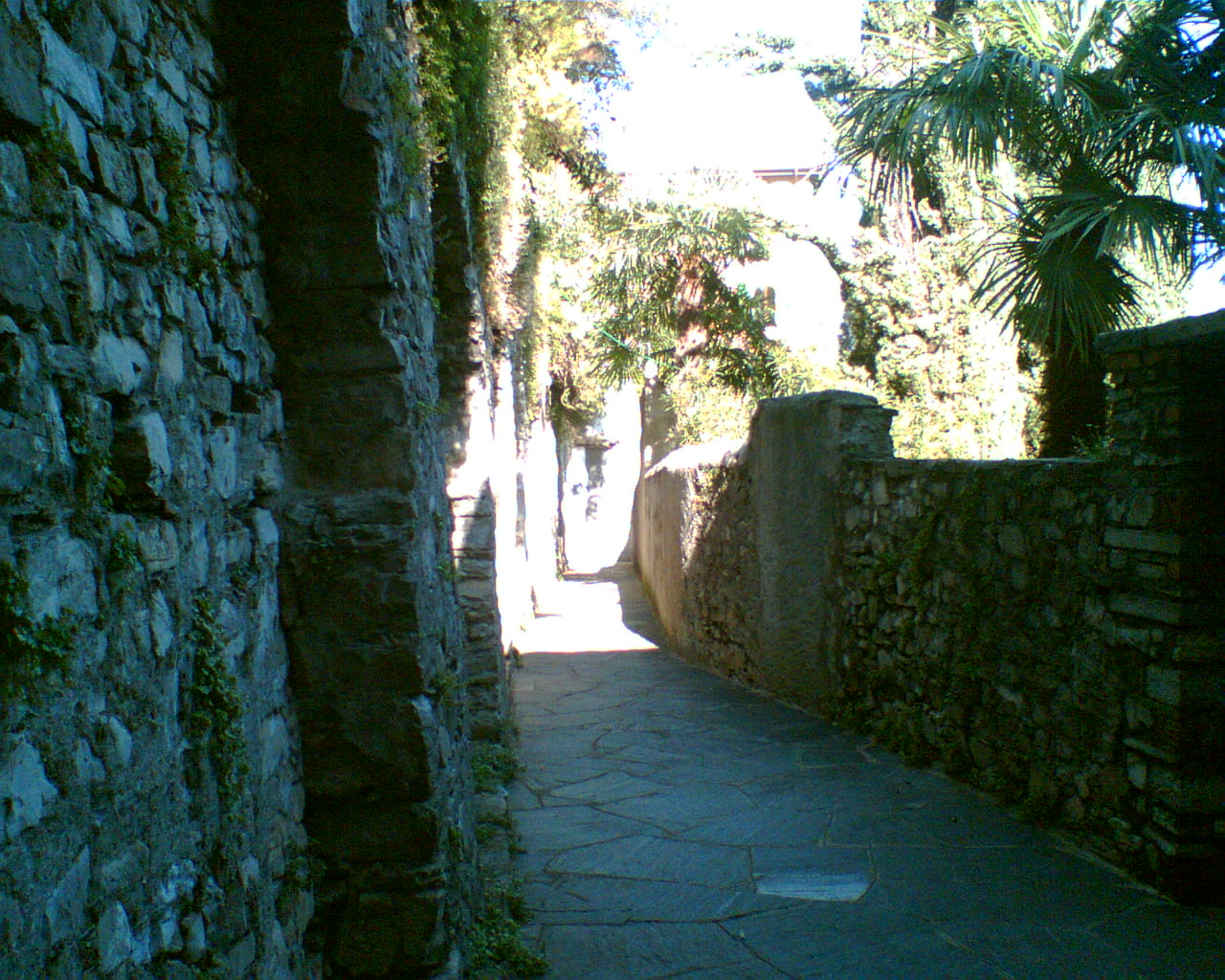 the walkway between the stone walls has stones on both sides