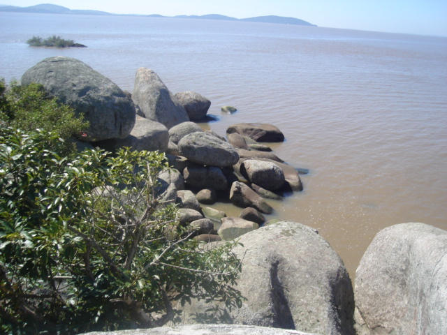a number of large rocks near water