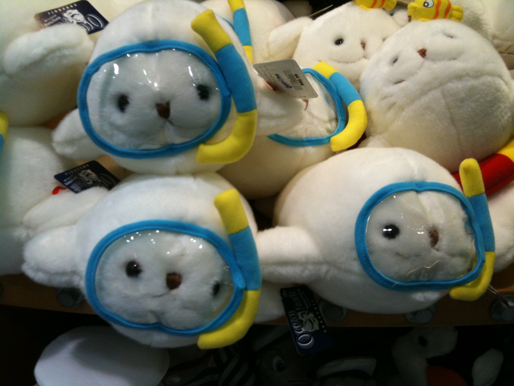 a bunch of stuffed animals are wearing yellow and blue frames