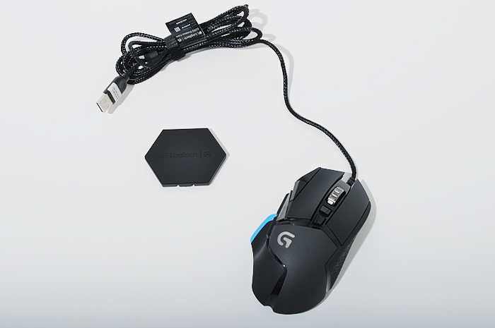 a computer mouse sitting next to a set of black and blue peripherals