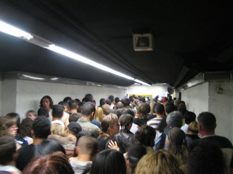 a group of people standing in a subway station