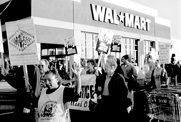 a crowd of people walking past a walmart store