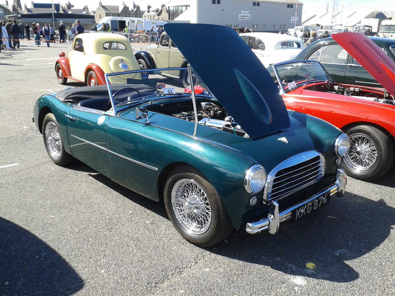 some very nice looking old time cars in a parking lot