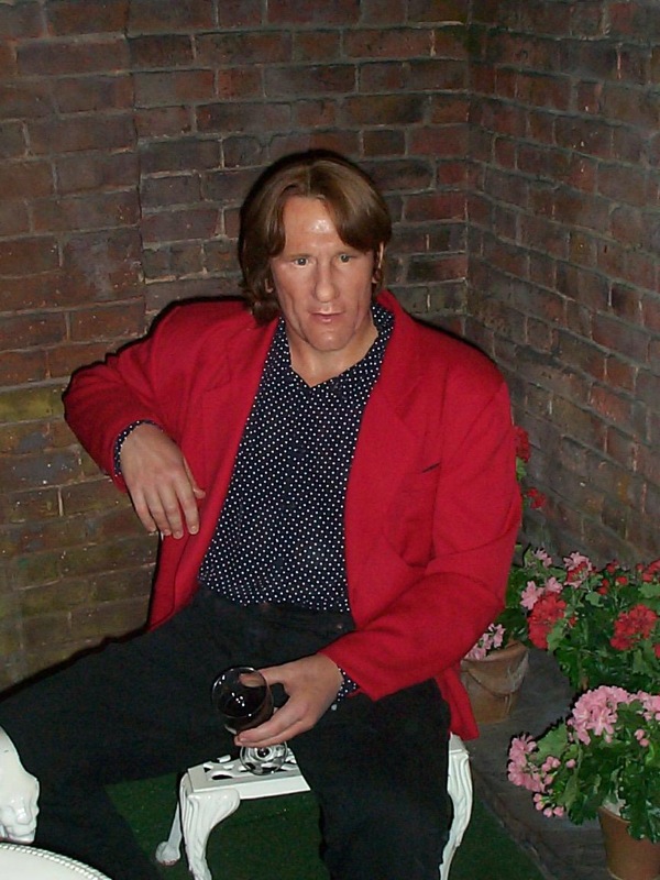 a man sits in a chair with flowers near him
