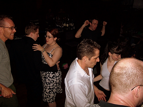 people in crowded bar having fun on dance floor