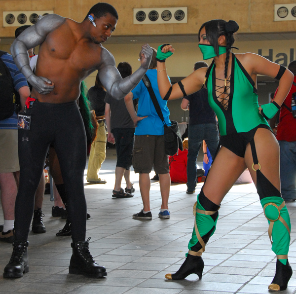 two people in costumes standing together on a street