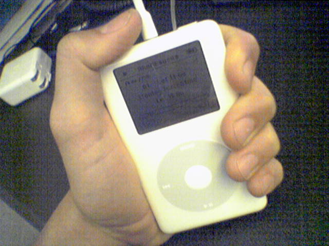 person holding a mp3 player in their hands