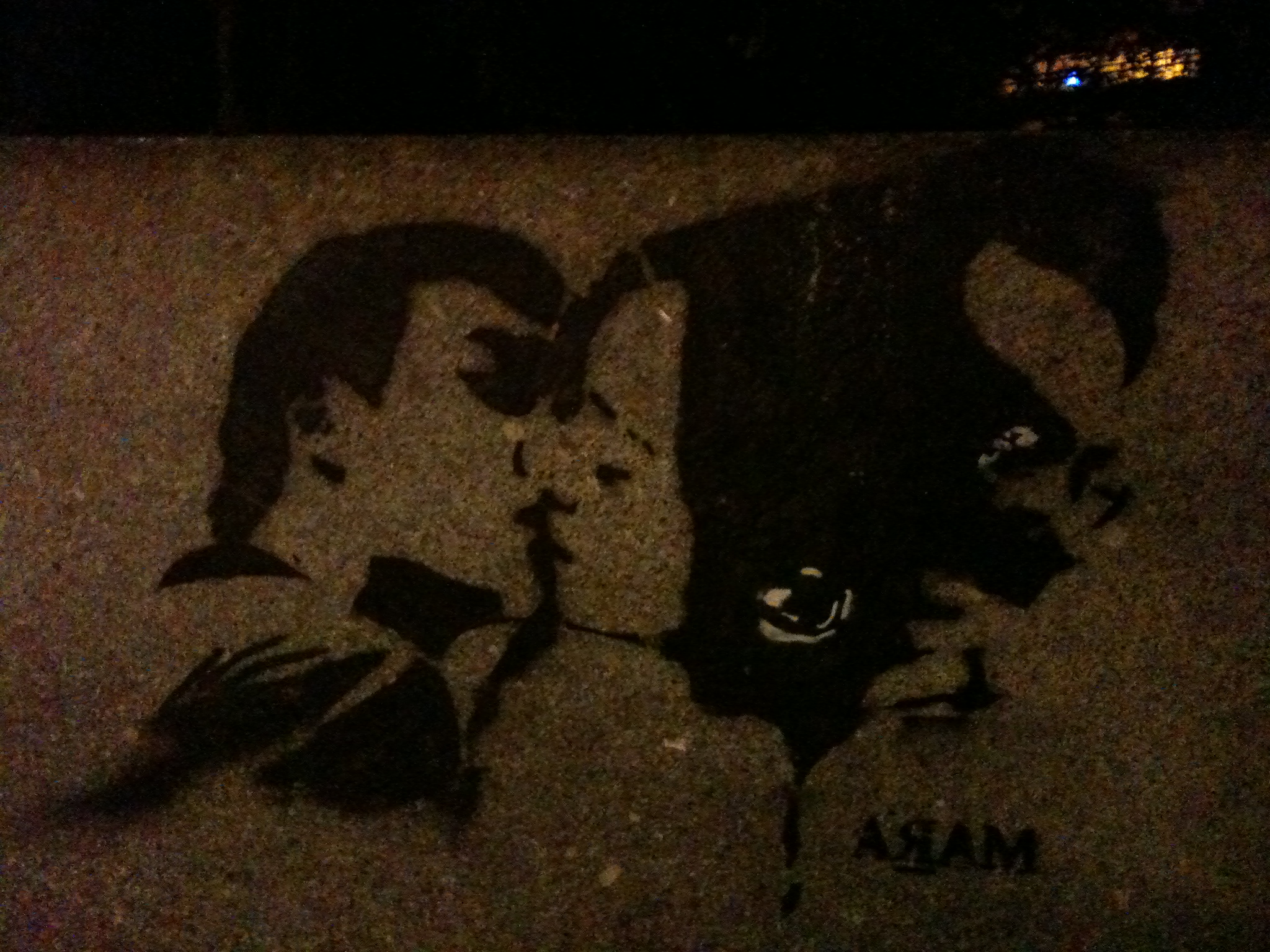 a stencil of two people's faces facing each other