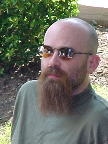 a man with sunglasses and beard with short hair