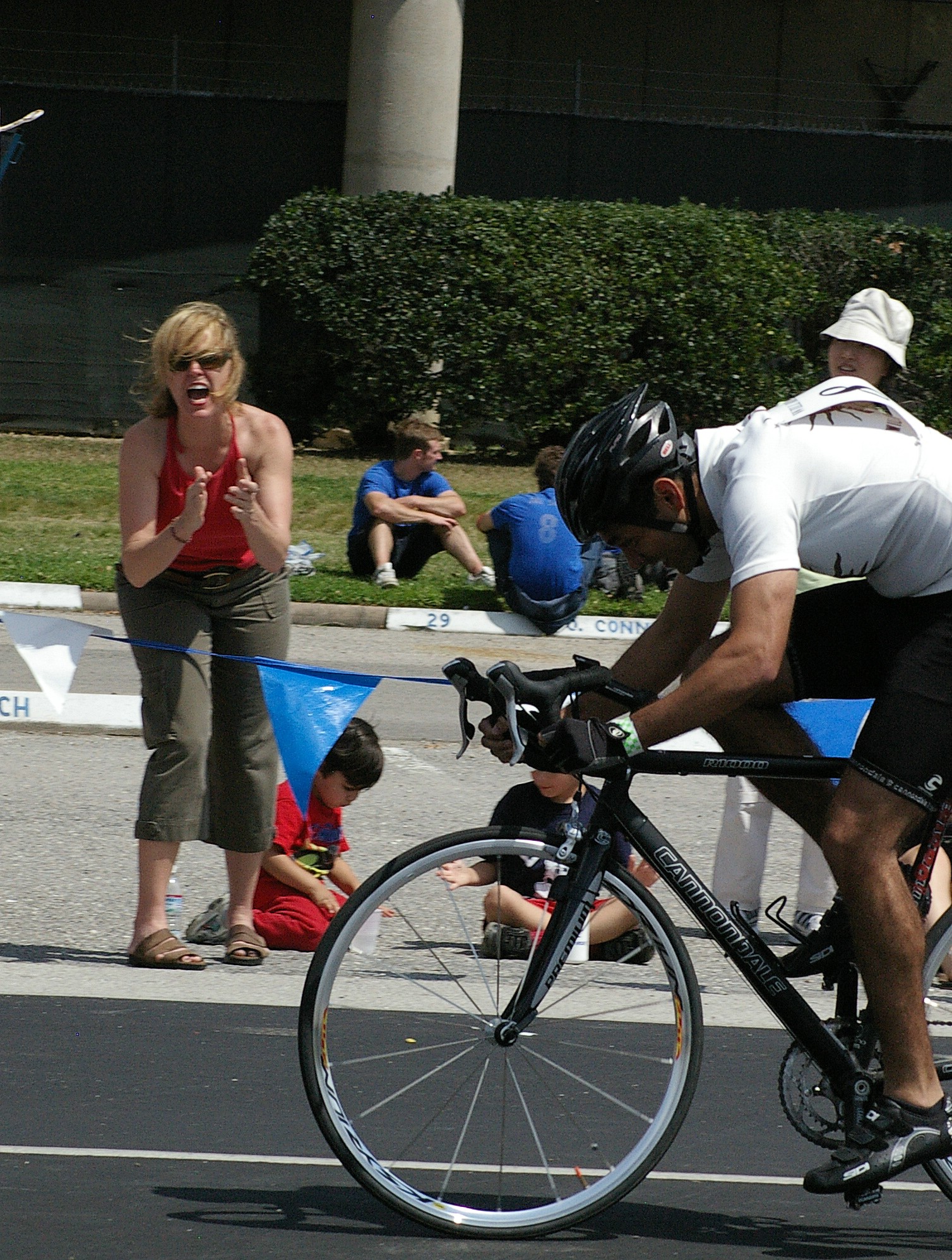 a cyclist with a large helmet on, is racing a bike