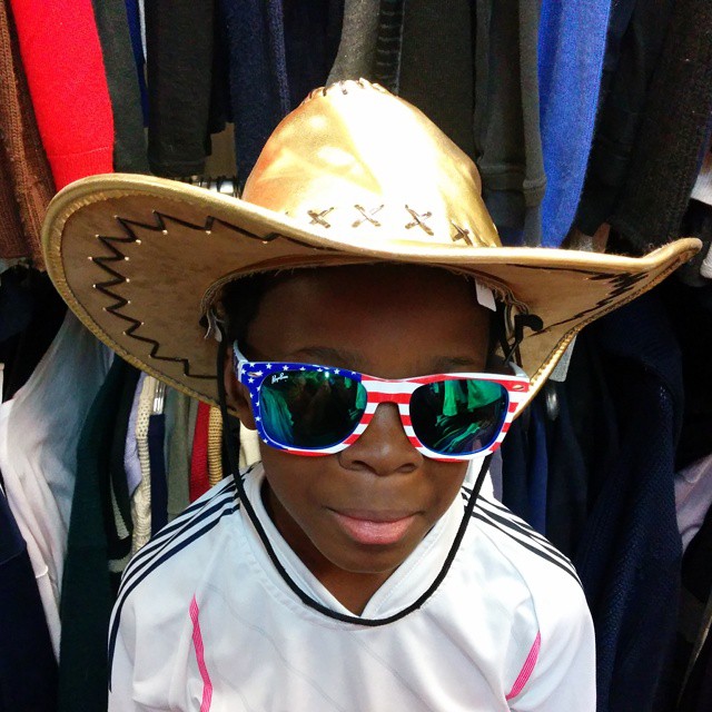 a person wearing sunglasses and a cowboy hat
