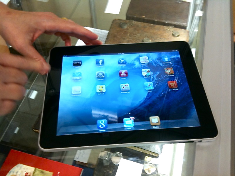 a person is holding a tablet on their hand