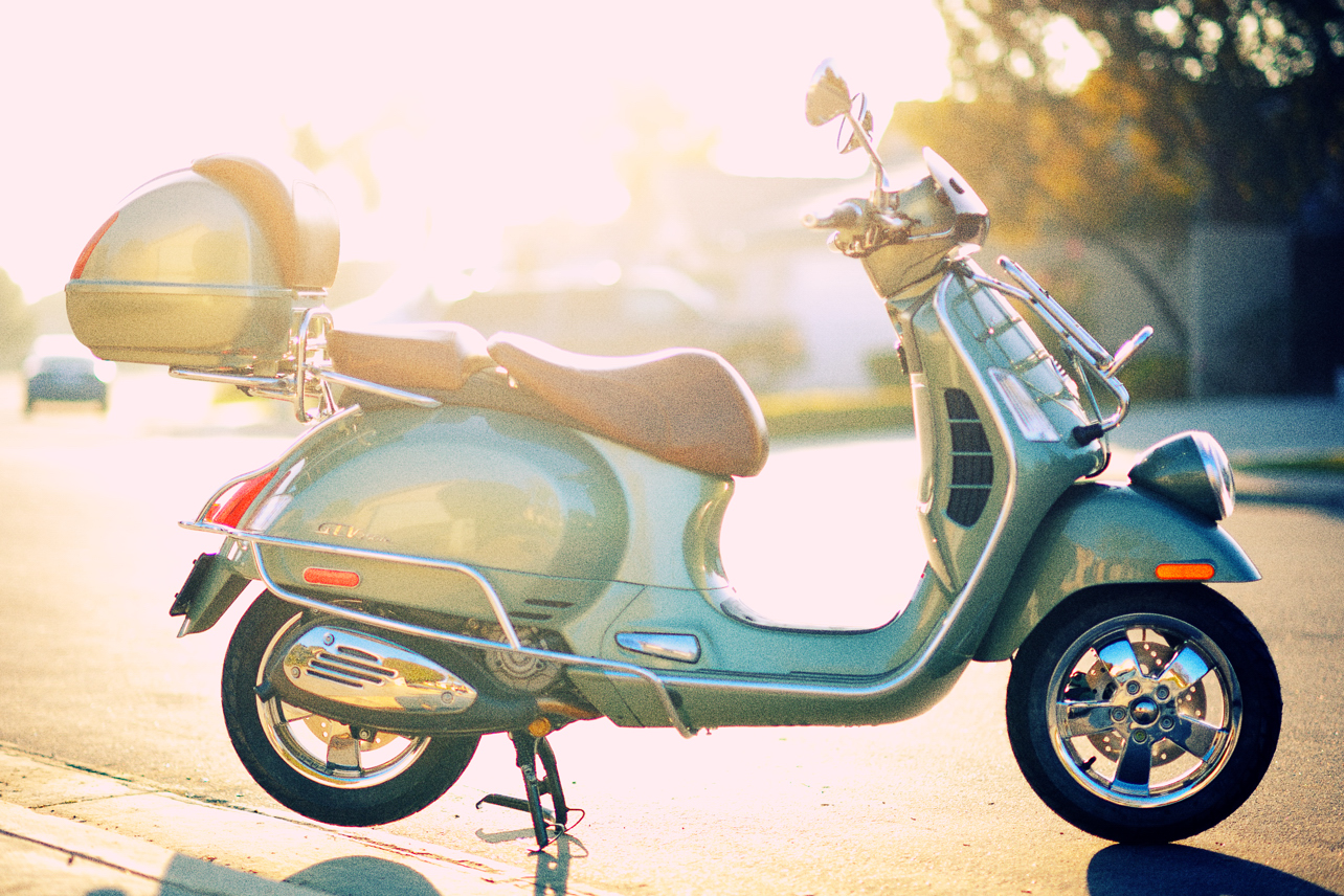 a moped sits parked in front of the road