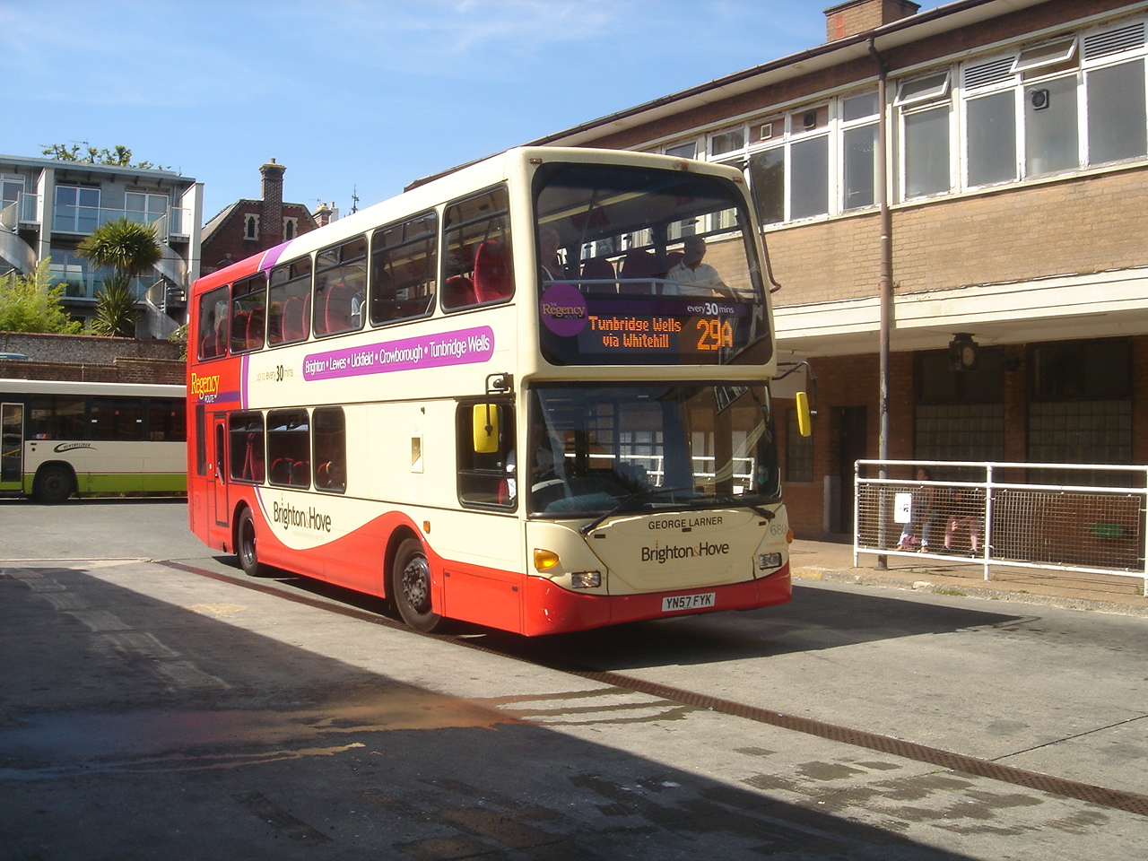 an open topped double decker bus on a road