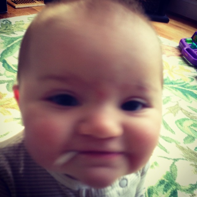 a baby with some kind of mustache on his head