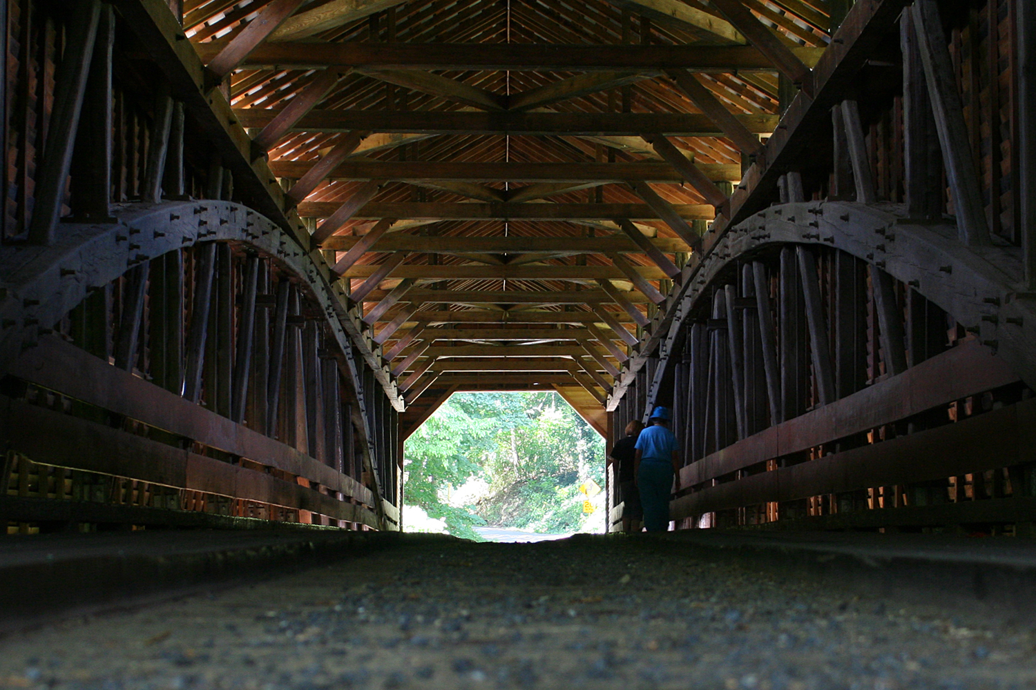 an empty bridge with a person in the tunnel