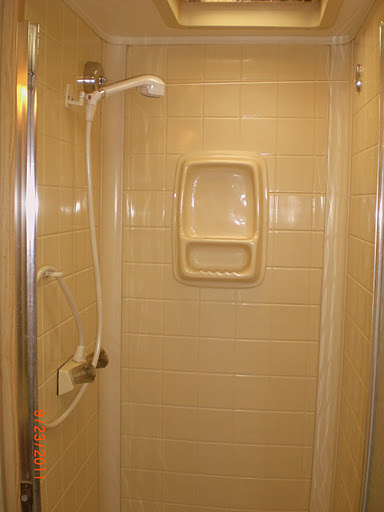 small white shower in an enclosed bathroom