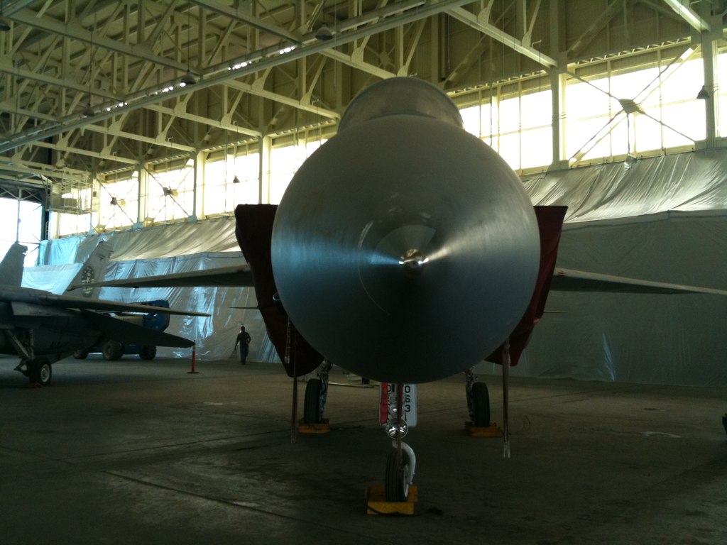 some fighter jets parked in the hangar for display