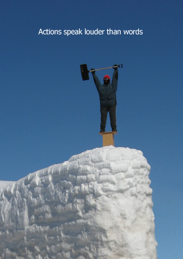 a person holding a hammer on top of a snow covered mountain