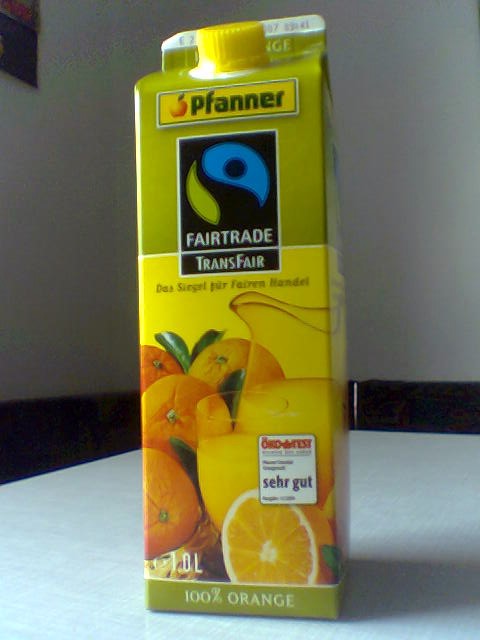 orange juice is served from carton and on a table