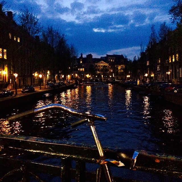 a bike is sitting outside next to a railing