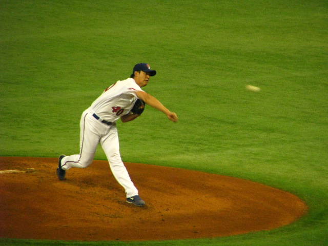 a man throwing a baseball from a mound
