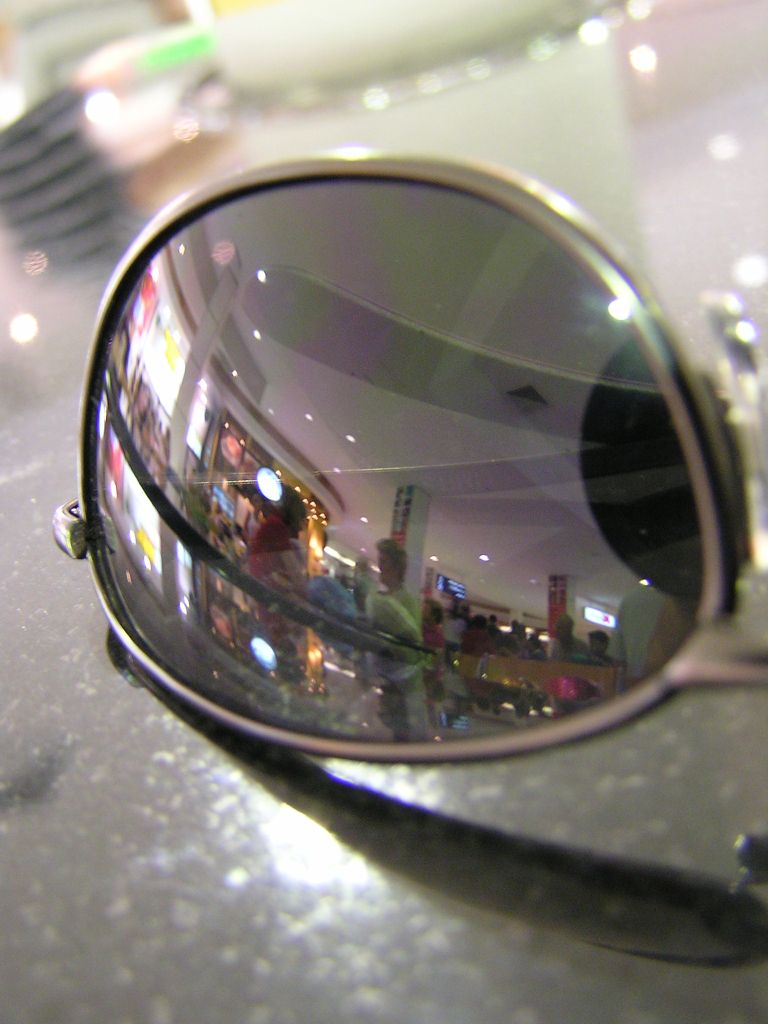 the reflection of a city in the sunglasses