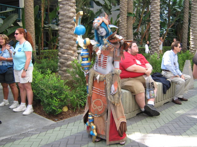 a couple is sitting on a bench with costumes on