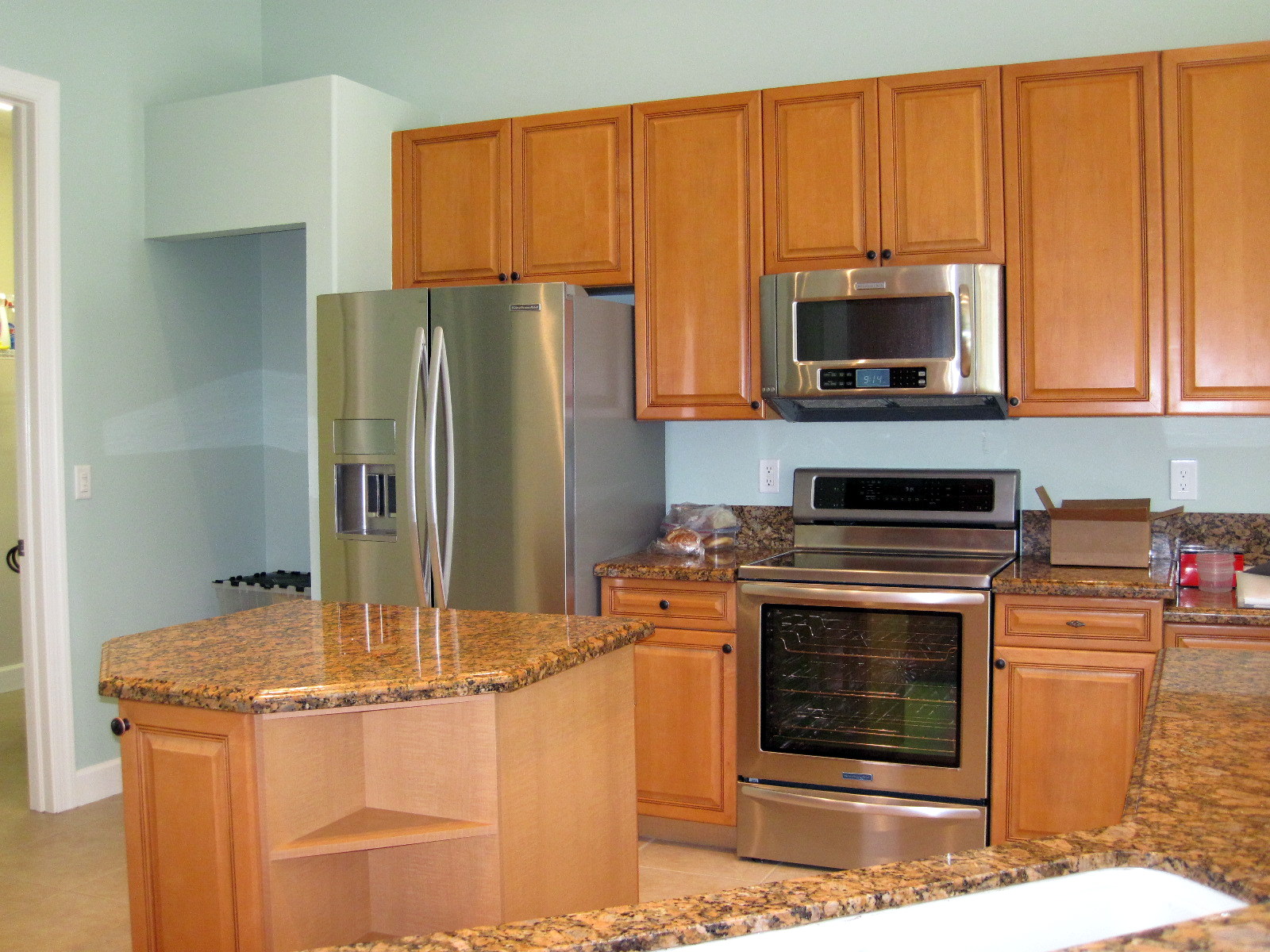 a kitchen with granite counters and stainless steel appliances