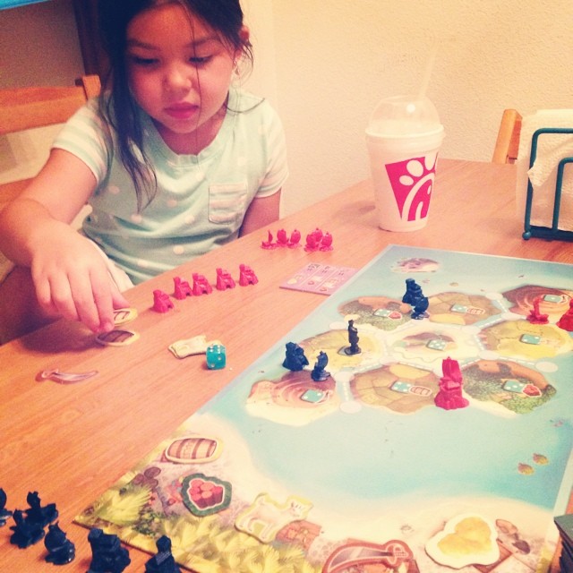 the girl is playing with her board game