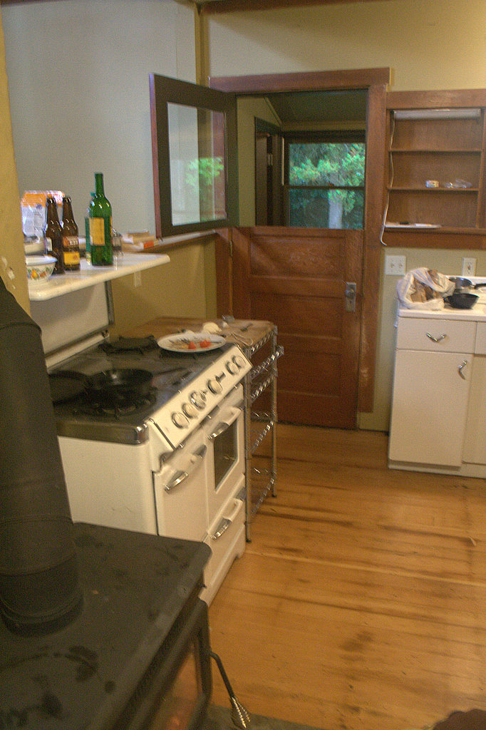 a kitchen with an oven and a stove top in it