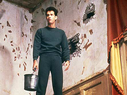 a man stands with two buckets next to a doorway
